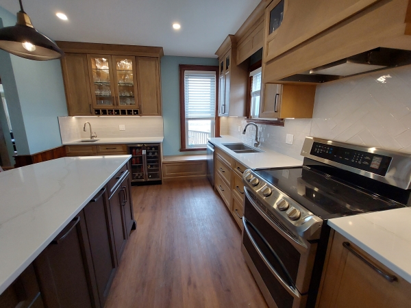 kitchen with stone countertops, custom cabinets, and wood look floorings